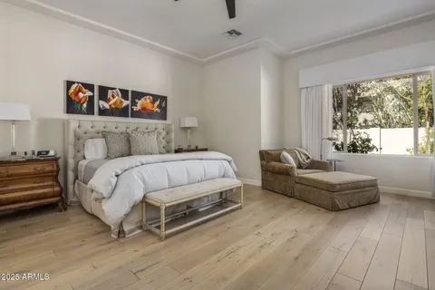 a bedroom with a bed and a large window