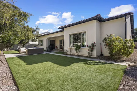 a view of a house with backyard and porch