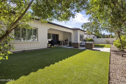 a view of a house with a backyard and a patio