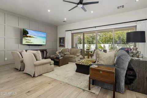 a living room with furniture tv and a large window