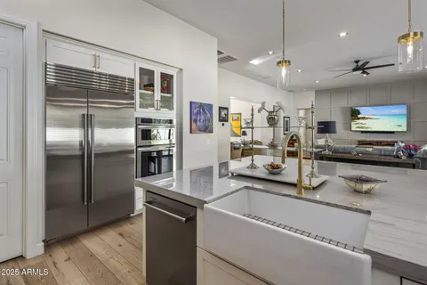 a kitchen with stainless steel appliances granite countertop a refrigerator and a counter space