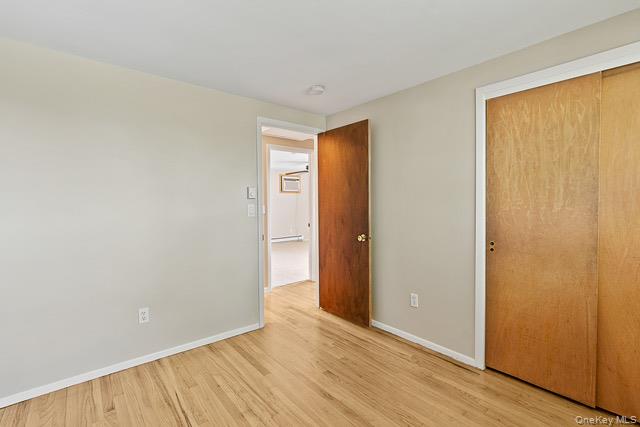 10 Brooker Drive Newburgh, NY 12550 - Photo 13 of 33 a view of an empty room with wooden floor and a window