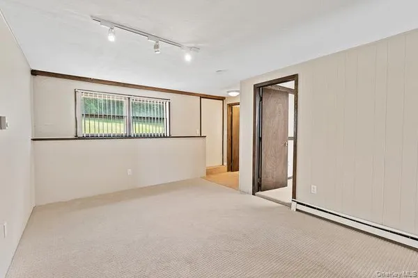 an empty room with windows and closet