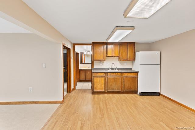10 Brooker Drive Newburgh, NY 12550 - Photo 22 of 33 a kitchen with a refrigerator a stove top oven a counter space and a window