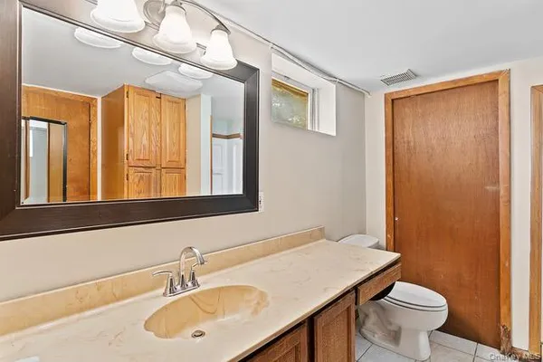 a view of a kitchen with sink and cabinets