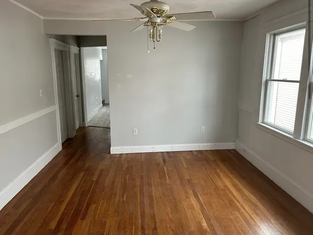 wooden floor in an empty room with a window