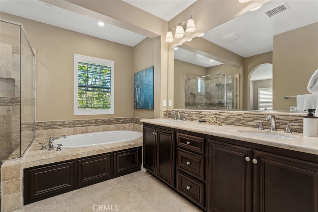 20 Old Mission Road Aliso Viejo, CA 92656 - Photo 19 of 35 a spacious bathroom with a double vanity sink large mirror and a bathtub