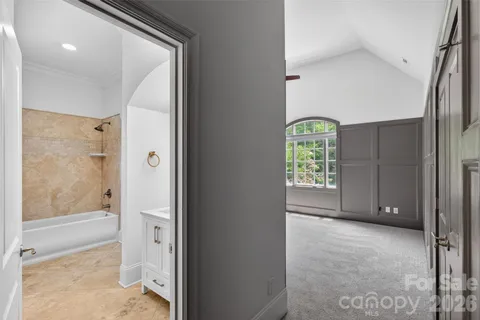 a bathroom with a granite countertop sink a toilet and shower