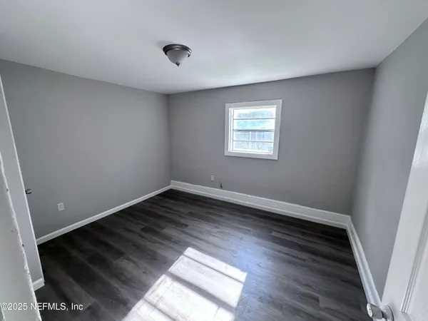 a view of an empty room and wooden floor