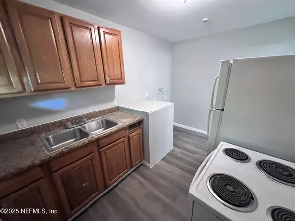 a utility room with sink dryer and washer