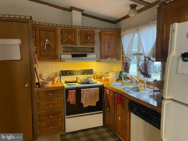 a utility room with stainless steel appliances granite countertop a stove and a refrigerator