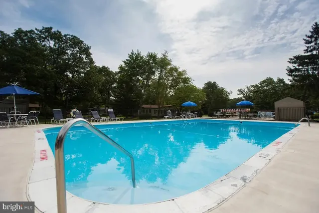 swimming pool view with a sitting space