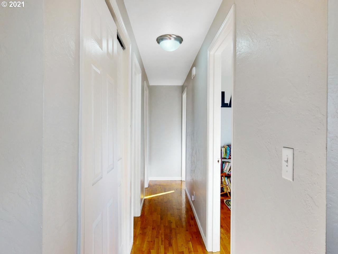 3440 C Street Springfield, OR 97478 - Photo 11 of 21 a view of hallway with stairs and wooden floor