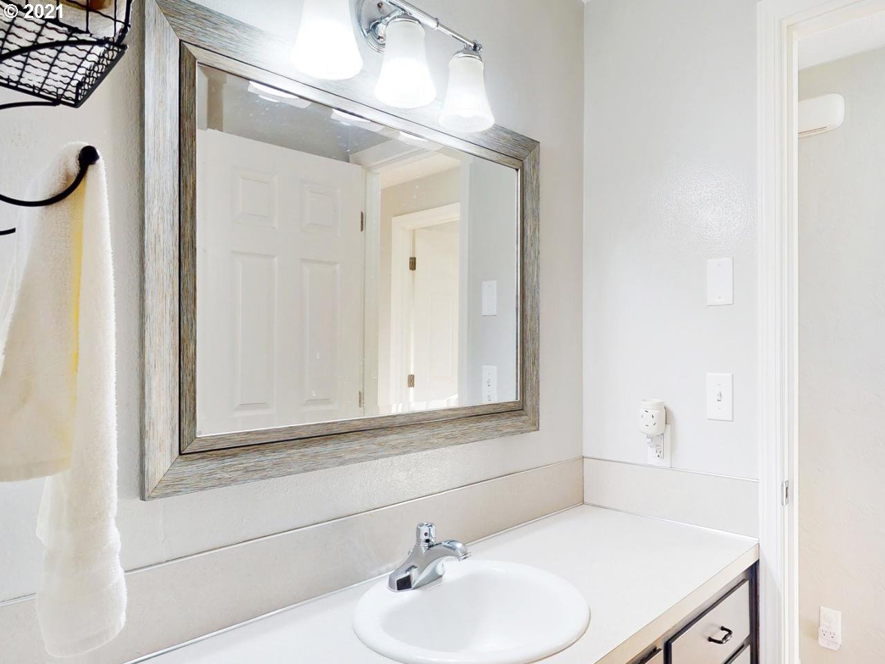 3440 C Street Springfield, OR 97478 - Photo 12 of 21 a bathroom with a sink a vanity and a mirror