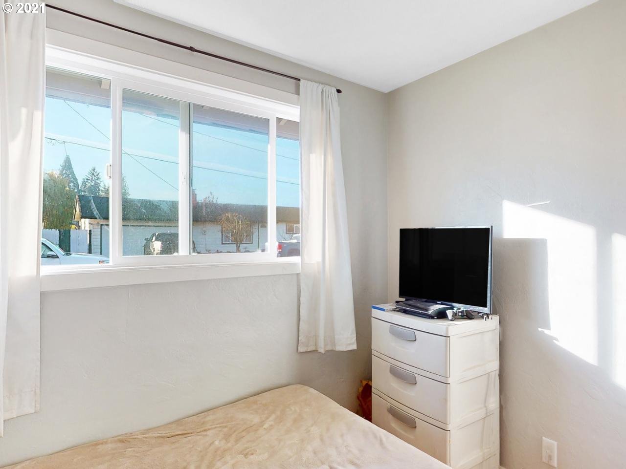 3440 C Street Springfield, OR 97478 - Photo 15 of 21 a room with a flat screen tv and a window