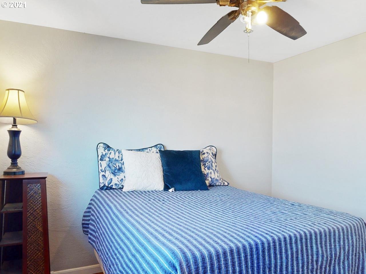 3440 C Street Springfield, OR 97478 - Photo 16 of 21 a bedroom with a bed and a lamp