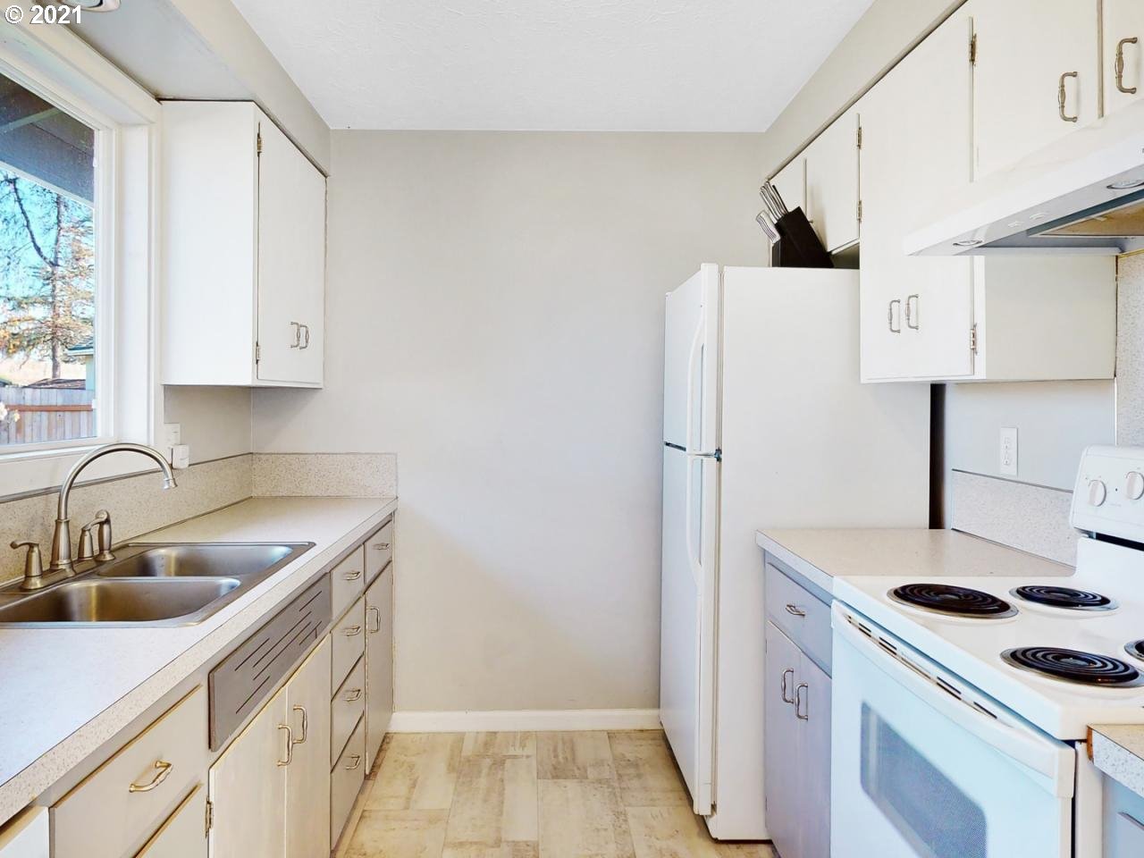 3440 C Street Springfield, OR 97478 - Photo 7 of 21 a kitchen with a stove sink and refrigerator