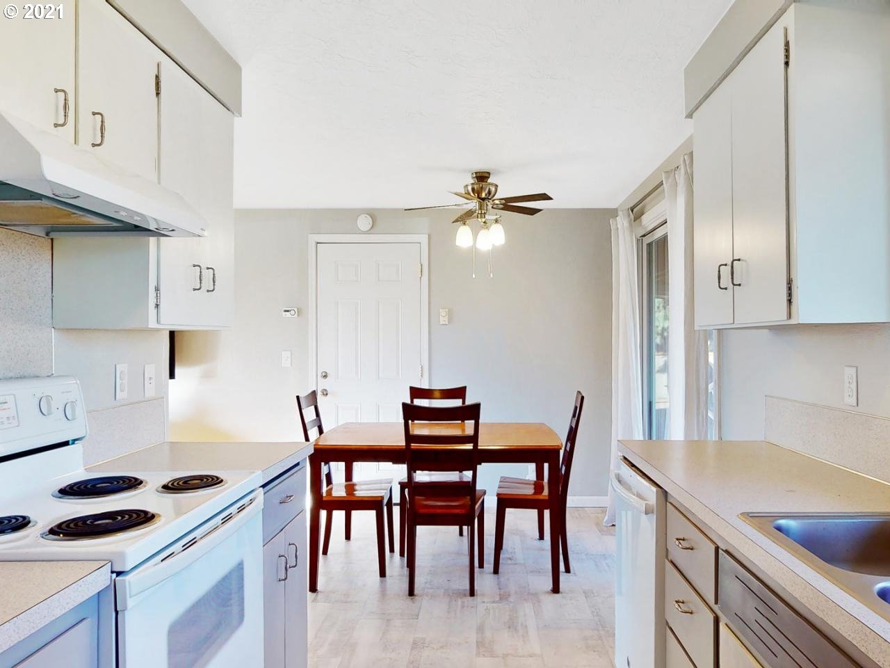 3440 C Street Springfield, OR 97478 - Photo 9 of 21 a kitchen with granite countertop a table chairs stove and cabinets