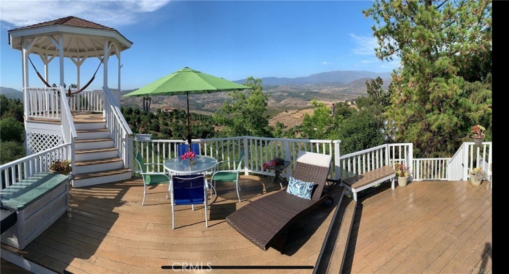 10210 Lilac Ridge Road Escondido, CA 92026 - Photo 12 of 26 a view of a roof deck with chair and wooden floor
