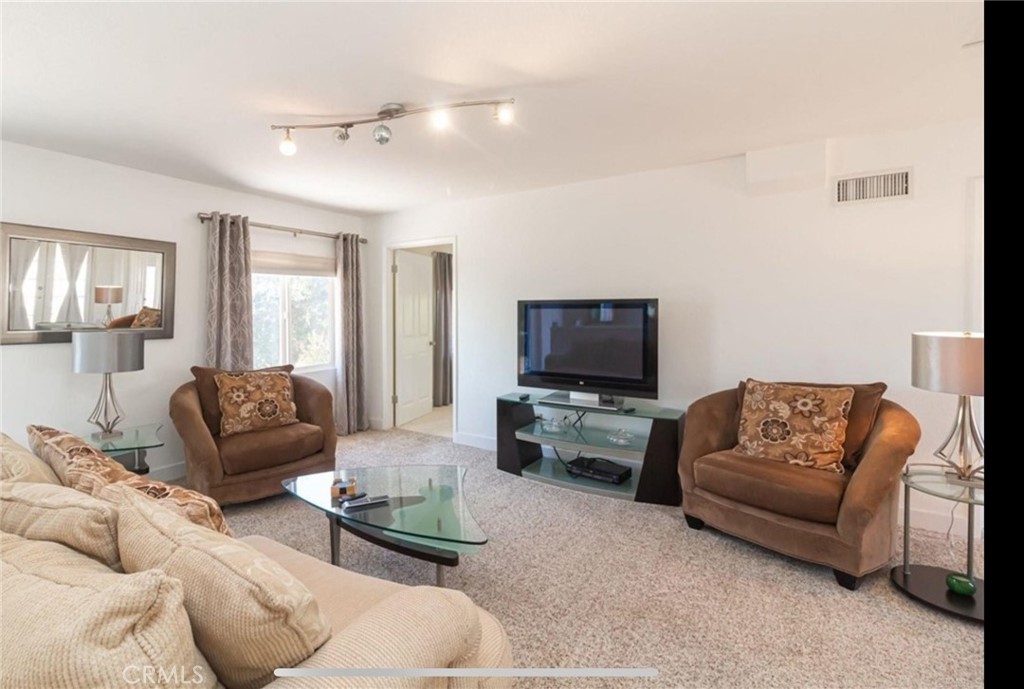 10210 Lilac Ridge Road Escondido, CA 92026 - Photo 19 of 26 a living room with furniture and a flat screen tv