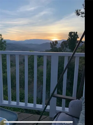 a view of a balcony with two chairs