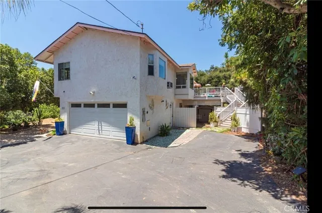 a view of a house with a patio and a yard