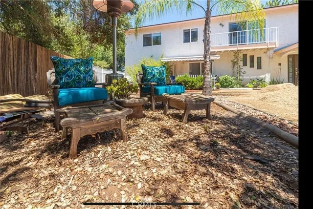a view of a patio with table and chairs and potted plants