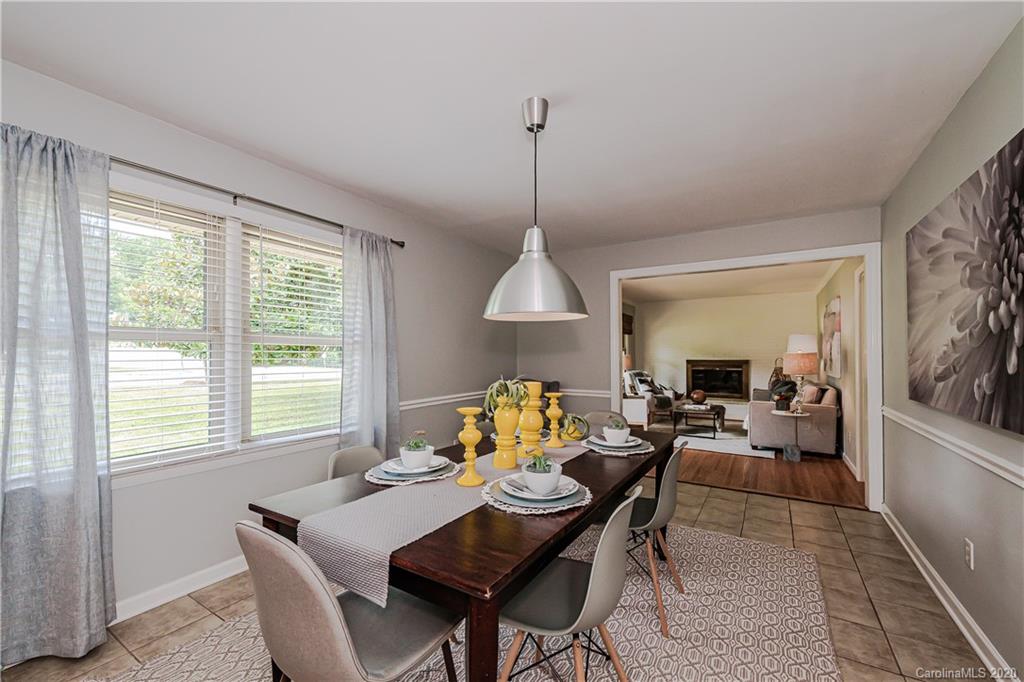 441 Scaleybark Road Charlotte, NC 28209 - Photo 11 of 24 a dining room with furniture a chandelier and wooden floor