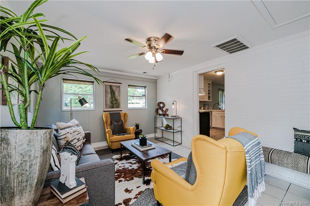 441 Scaleybark Road Charlotte, NC 28209 - Photo 13 of 24 a living room with furniture a chandelier and a window