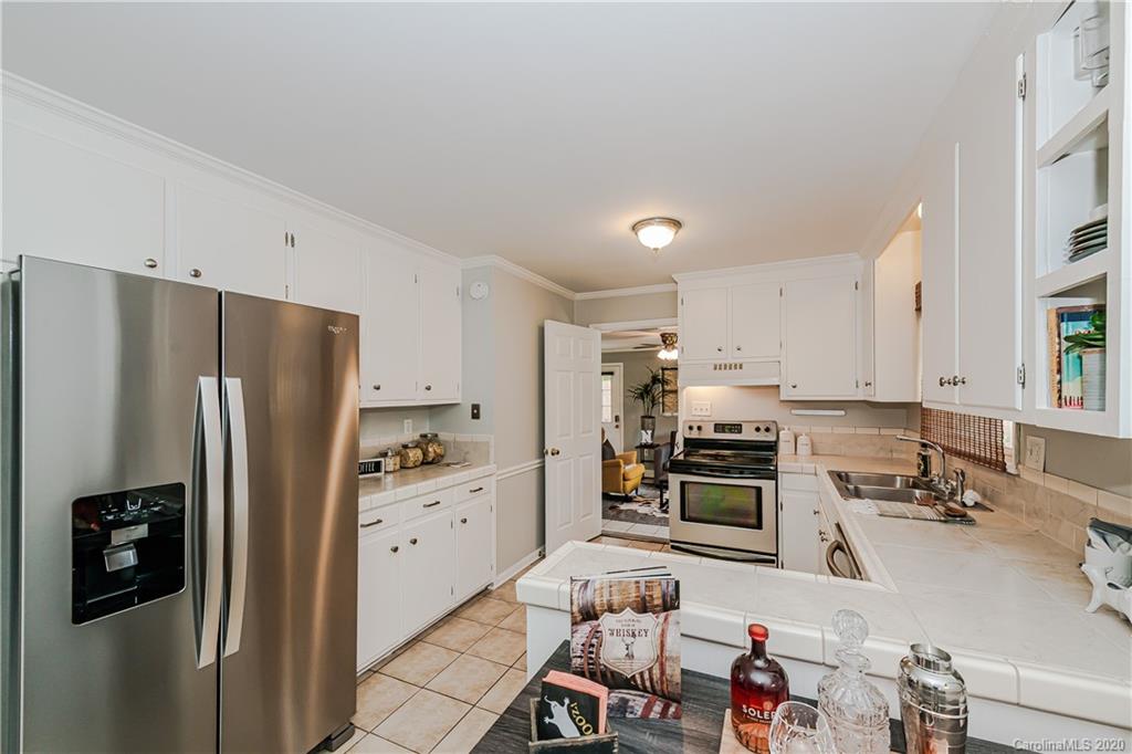 441 Scaleybark Road Charlotte, NC 28209 - Photo 8 of 24 a kitchen with stainless steel appliances granite countertop a refrigerator stove and sink