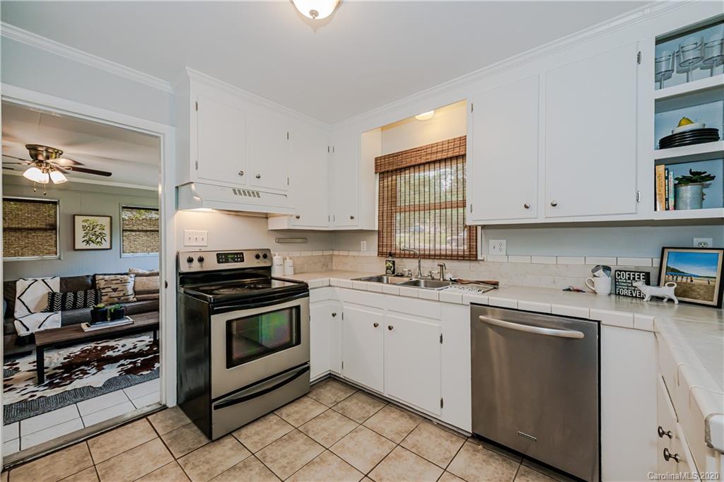 441 Scaleybark Road Charlotte, NC 28209 - Photo 9 of 24 a kitchen with cabinets appliances and a window