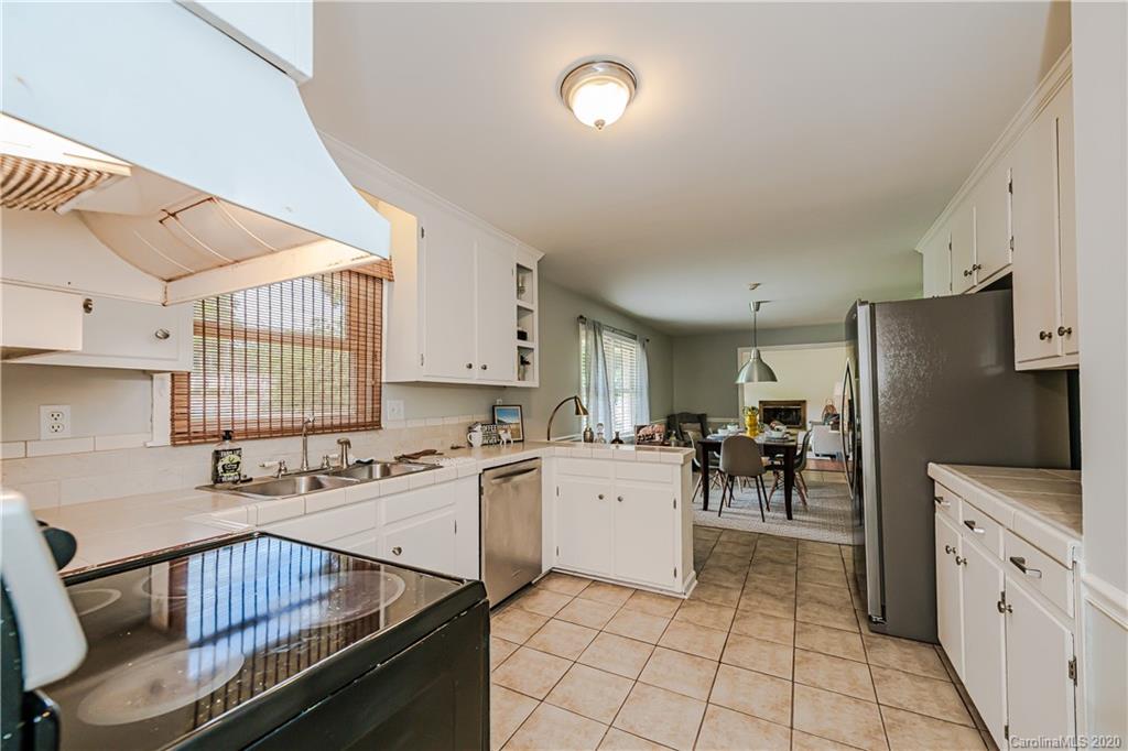 441 Scaleybark Road Charlotte, NC 28209 - Photo 10 of 24 a kitchen with a sink a stove cabinets and stainless steel appliances