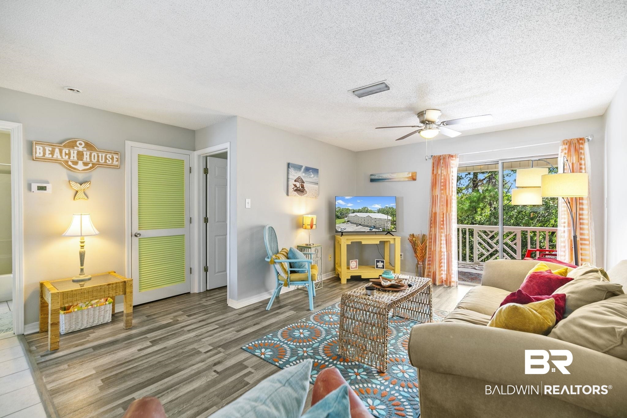 25957 Canal Road, Unit 302 Orange Beach, AL 36561 - Photo 6 of 26 Living room featuring ceiling fan, hardwood / wood-style floors, and a textured ceiling