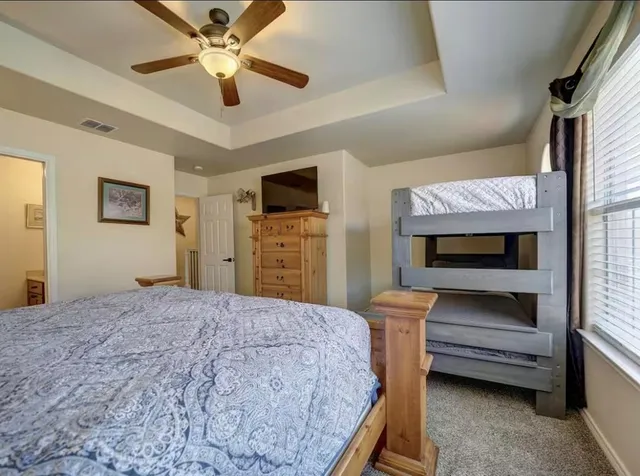 a bedroom with a bed and a chandelier