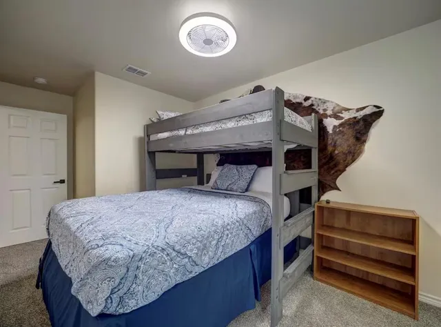 a bedroom with a bed and a mirror