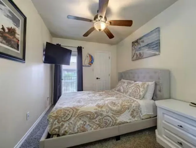 a bedroom with a bed and a painting on the wall