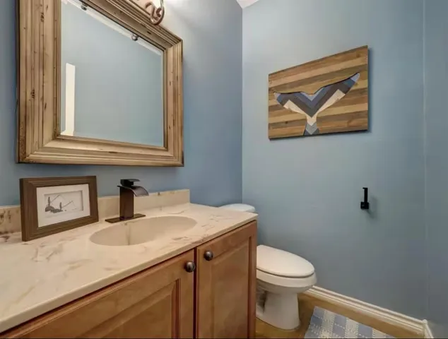 a bathroom with a sink vanity and a mirror