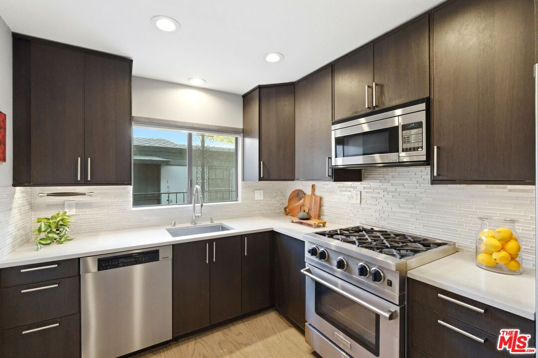 1013 16th Street, Unit 101 Santa Monica, CA 90403 - Photo 17 of 46 a kitchen with a stove and a sink
