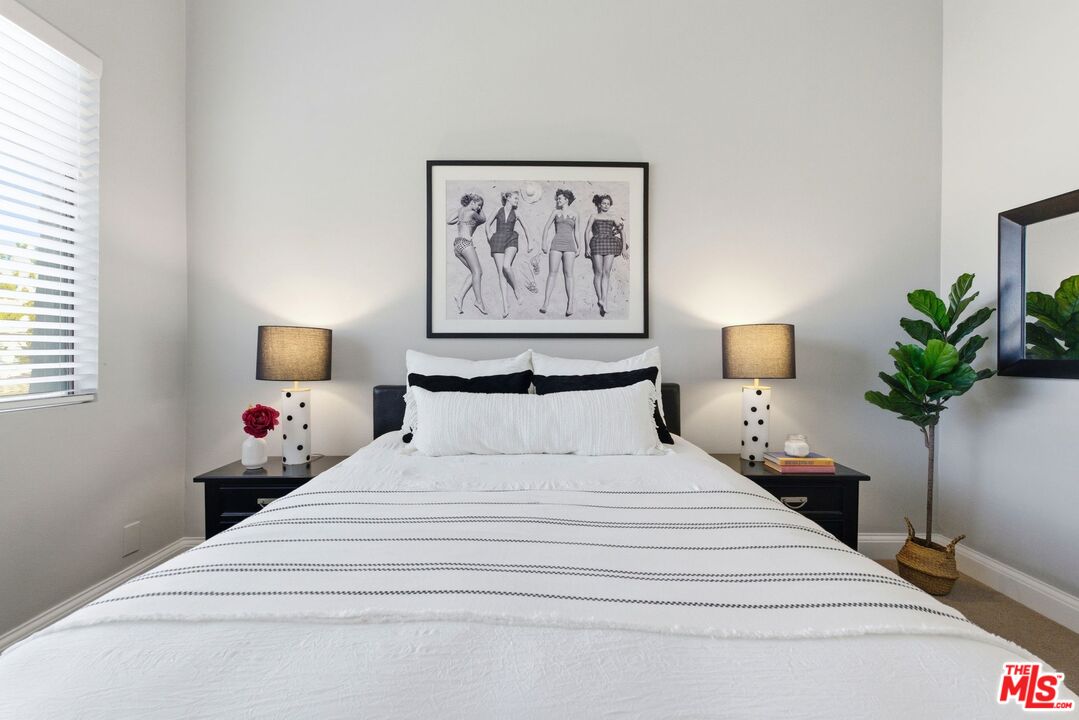 1013 16th Street, Unit 101 Santa Monica, CA 90403 - Photo 37 of 46 a bedroom with bed and painting on the wall