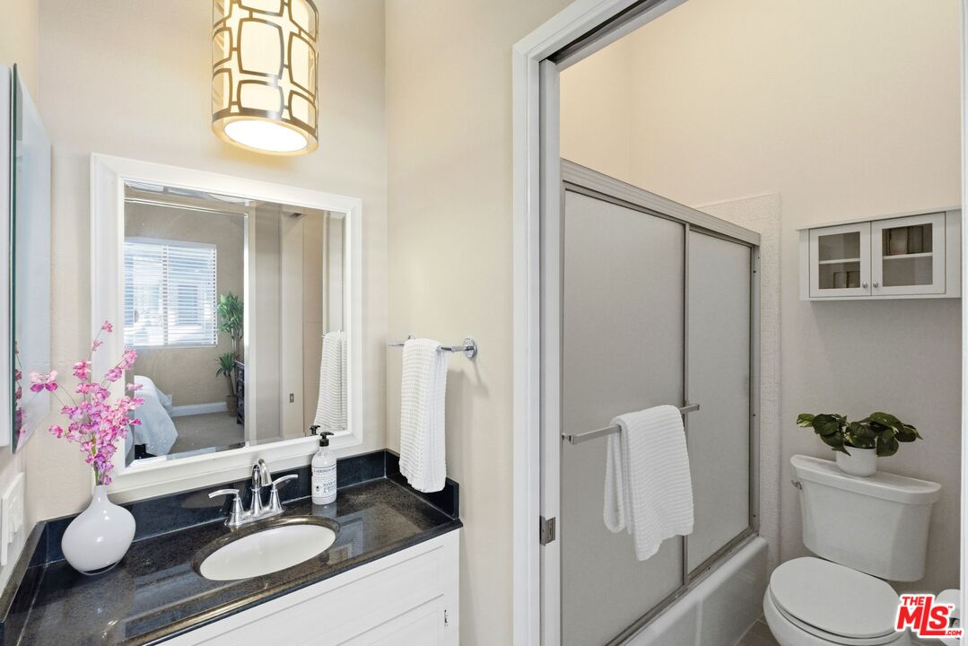 1013 16th Street, Unit 101 Santa Monica, CA 90403 - Photo 38 of 46 a bathroom with a granite countertop sink toilet and shower