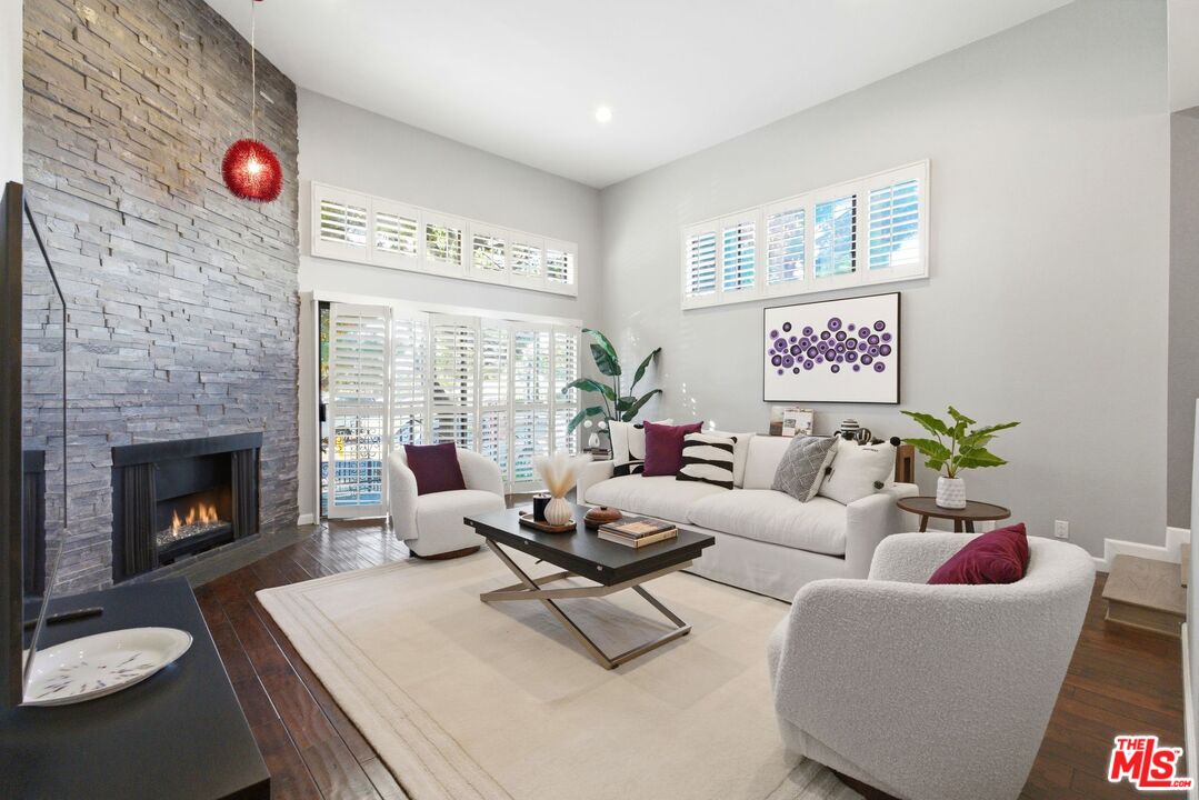 1013 16th Street, Unit 101 Santa Monica, CA 90403 - Photo 8 of 46 a living room with furniture and a fireplace