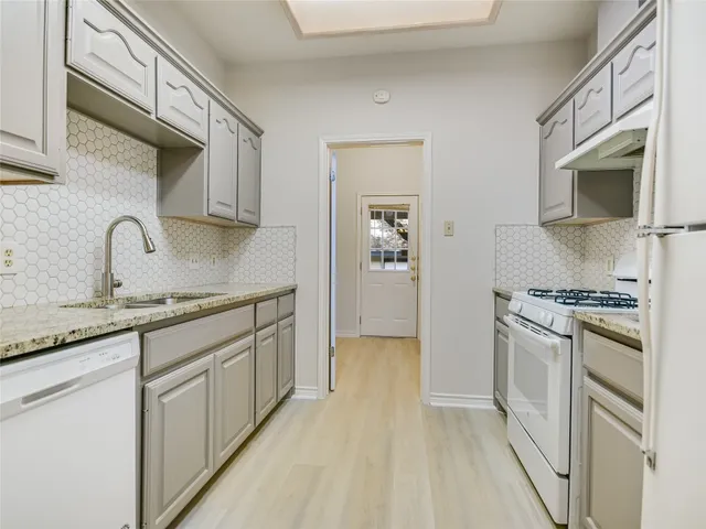 an empty room with a kitchen and a sink