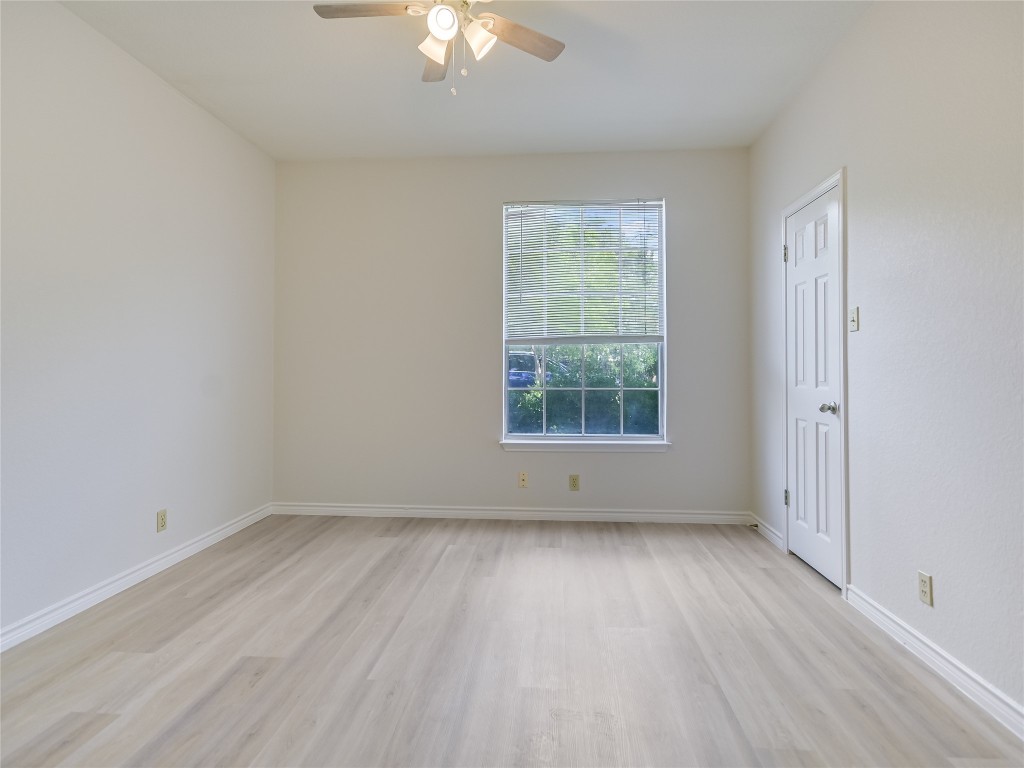 2601 Riddle Road, Unit A Austin, TX 78748 - Photo 7 of 10 an empty room with wooden floor and windows