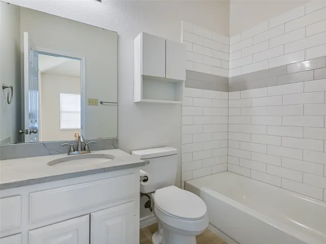 a view of a yard with wooden fence