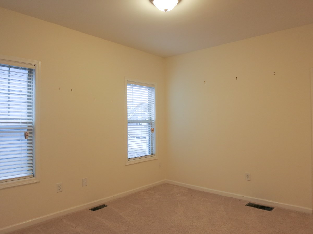 1556 Rodessa Run Raleigh, NC 27607 - Photo 17 of 25 This is Bedroom 3 which has access to the lg walk-in Attic storage area. Bedroom
