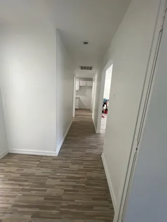 a kitchen with cabinets and wooden floor