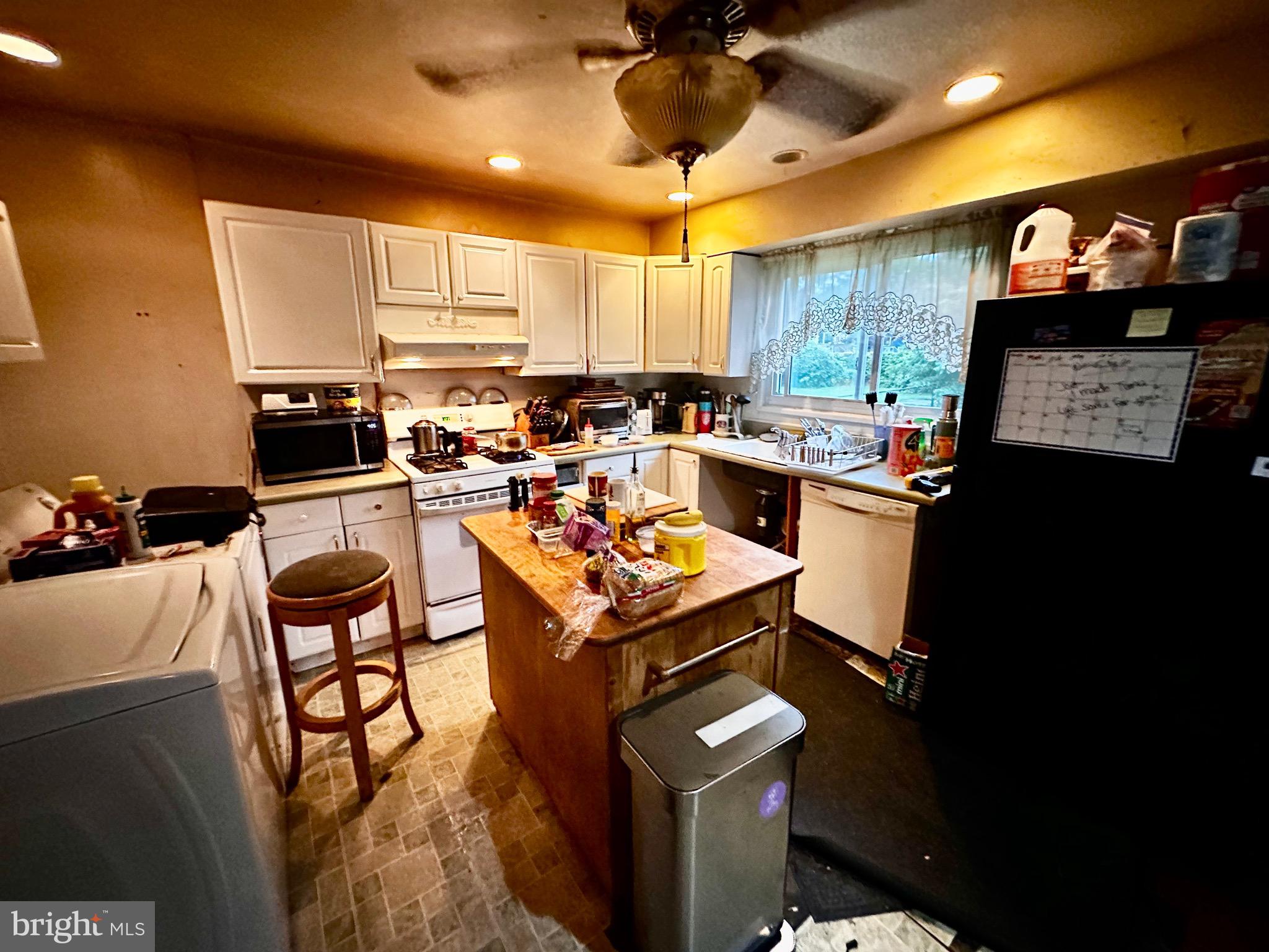 116 West Park Avenue Lindenwold, NJ 08021 - Photo 2 of 3 a kitchen with a stove a refrigerator and a dining table