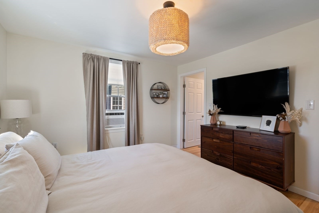 31 Broad Cove Road Hingham, MA 02043 - Photo 13 of 22 a bedroom with a bed and a flat screen tv