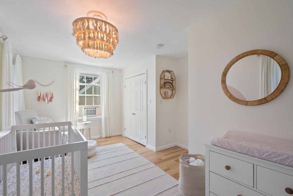 31 Broad Cove Road Hingham, MA 02043 - Photo 18 of 22 a bedroom with a bed and a large mirror on the dresser
