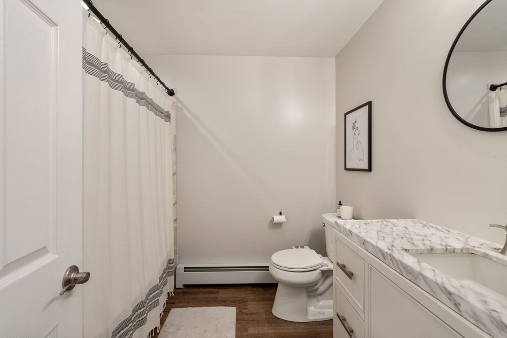 31 Broad Cove Road Hingham, MA 02043 - Photo 19 of 22 a bathroom with a granite countertop sink toilet and a mirror
